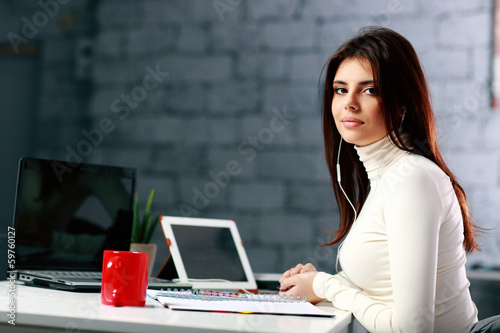 Young businesswoman sitting at the table 