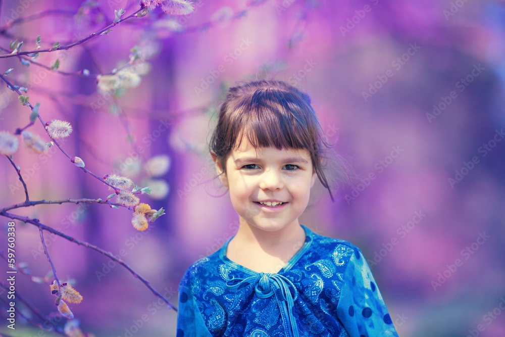 Portrait of happy little girl in the park in spring Portrait of happy little girl in the park in spring