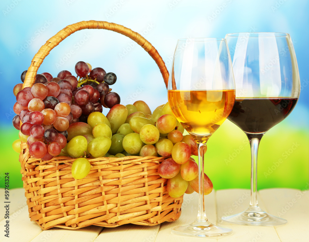Ripe grapes in wicker basket, and two glasses of wine, Ripe grapes in wicker basket, and two glasses of wine,