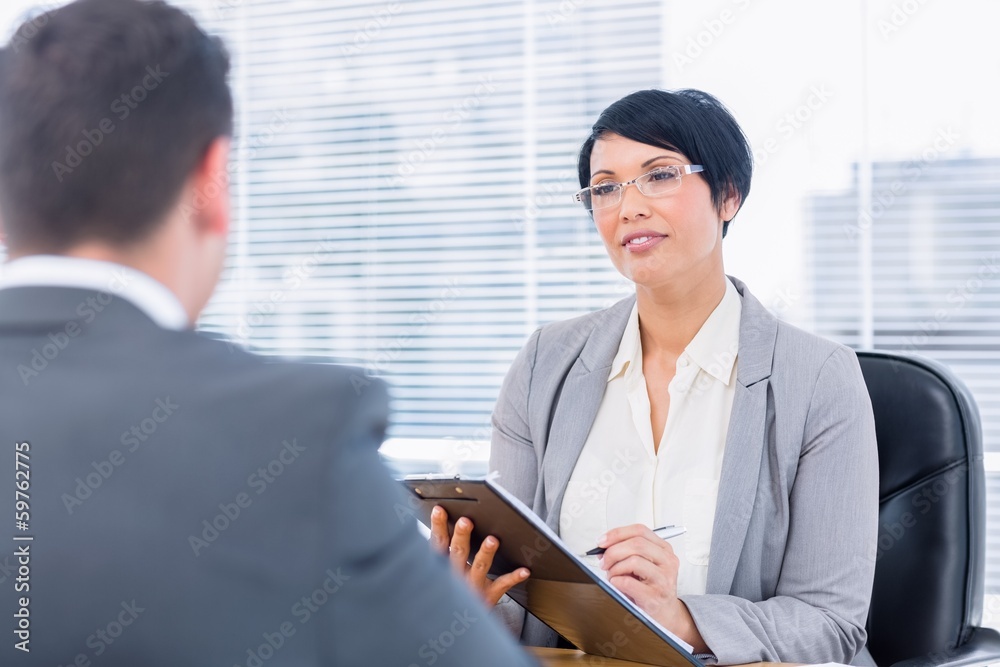 Recruiter checking the candidate during a job interview Recruiter checking the candidate during a job interview