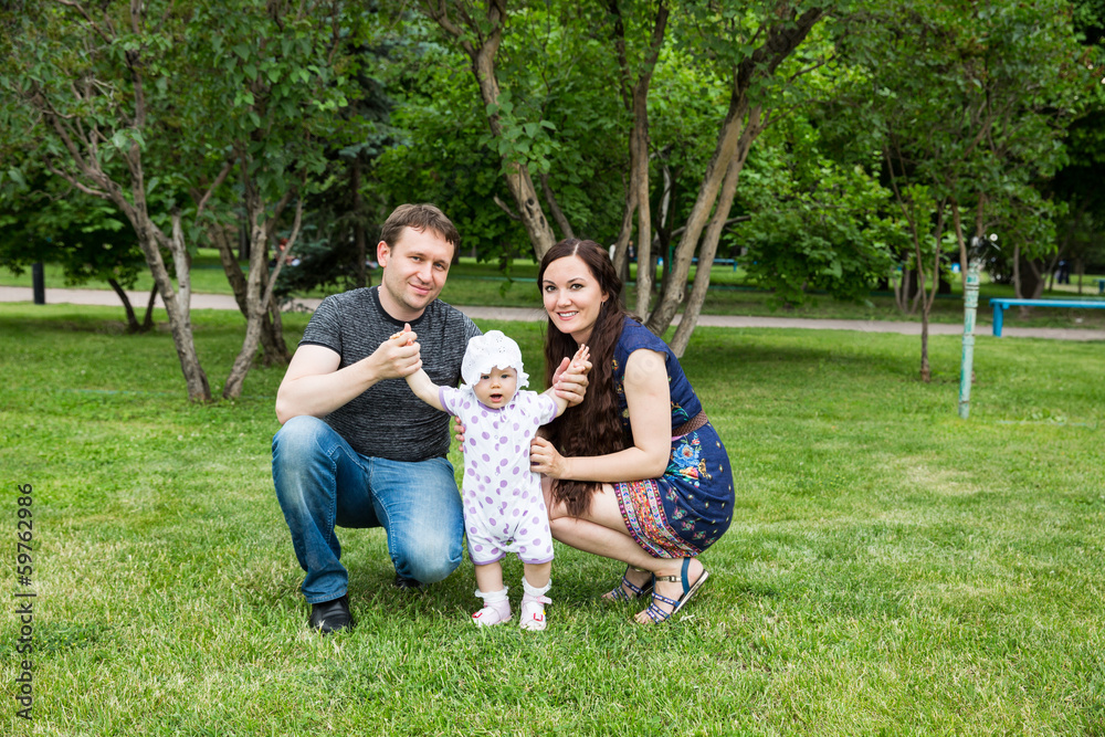 Obraz premium Happy family: mother, father and daughter baby