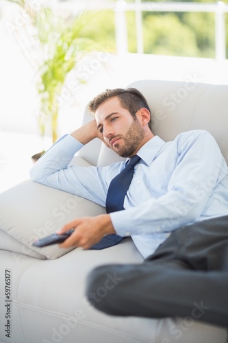 Relaxed well dressed man watching tv in living room © WavebreakMediaMicro