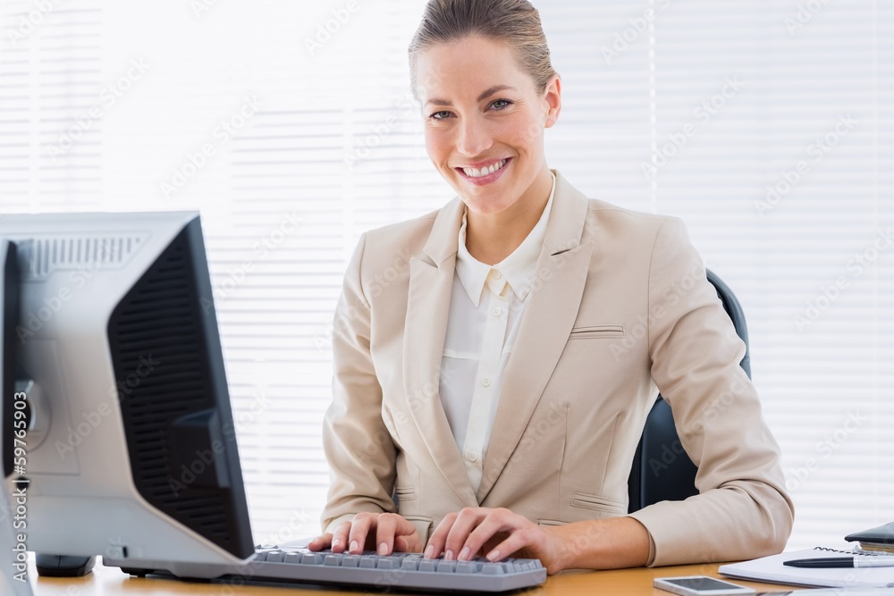 Businesswoman using computer at office desk Businesswoman using computer at office desk