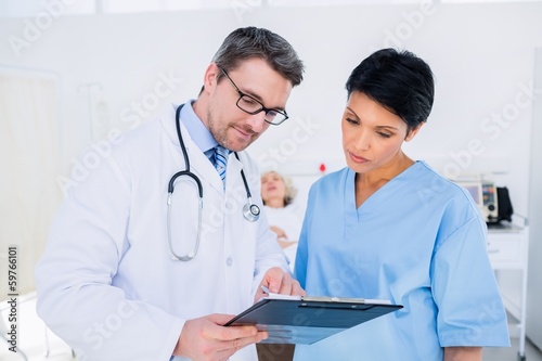 Doctors discussing medical reports