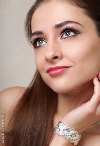 Beautiful makeup woman looking happy with bangle on hand