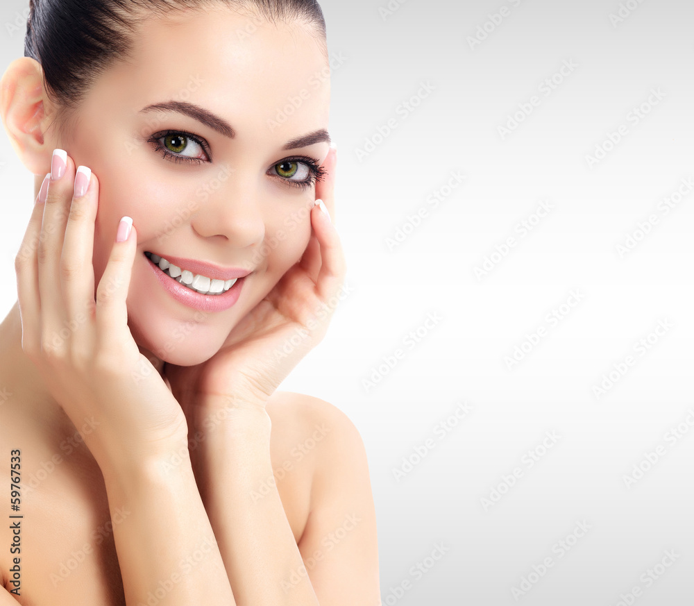 Pretty woman against a grey background with copyspace. Pretty woman against a grey background with copyspace.