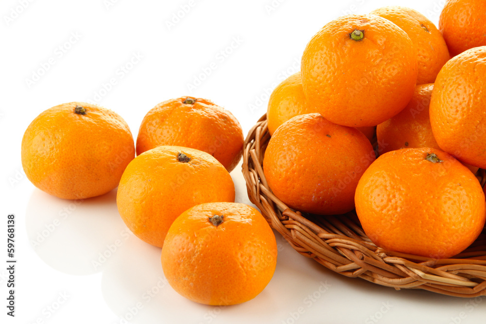 Ripe tangerines on wicker stand isolated on white Ripe tangerines on wicker stand isolated on white