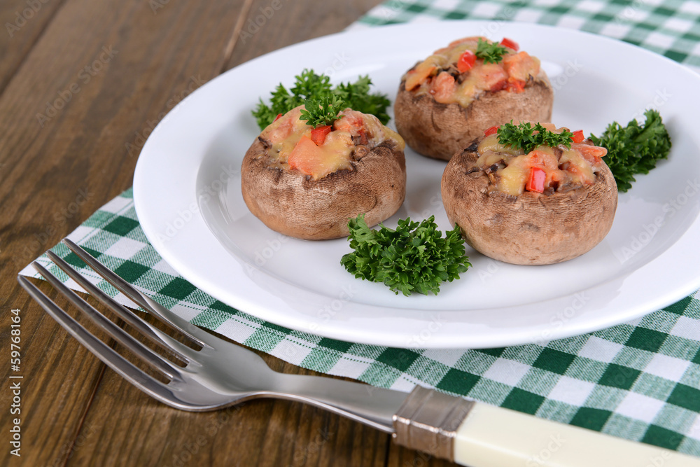 Stuffed mushrooms on plate on table close-up Stuffed mushrooms on plate on table close-up