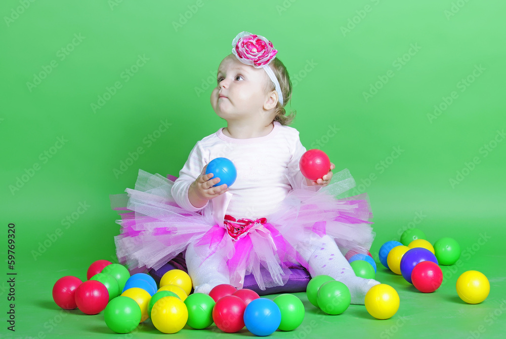 Small girl in rose suit on green background