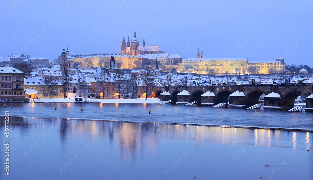 Evening colorful snowy Prague gothic Castle with Charles Bridge