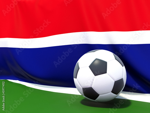 Flag of gambia with football in front of it