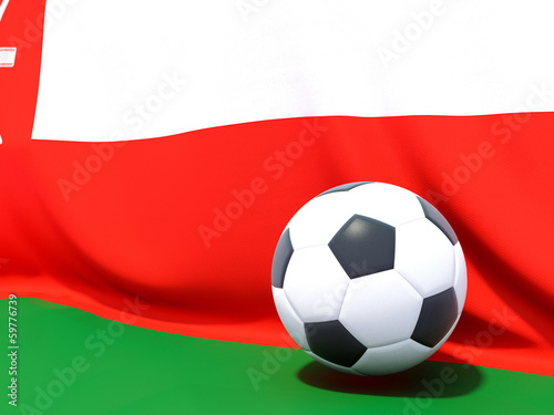 Flag of oman with football in front of it