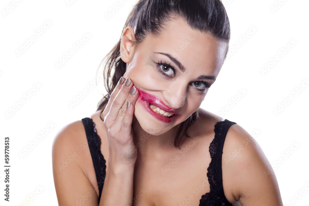 Fototapeta premium desperate beautiful girl removing her makeup by hand