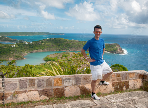 Fototapeta Naklejka Na Ścianę i Meble -  Man standing on top of cliff at Antigua, Caribbean