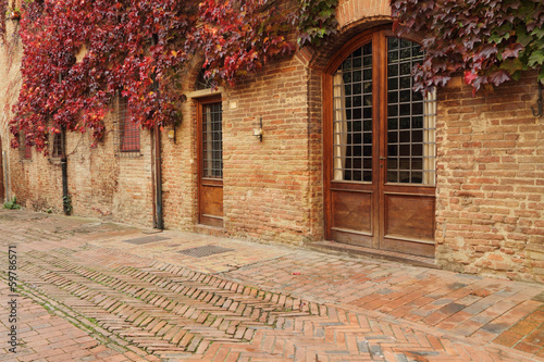 picturesque street in small old tuscan town  in autumnal colors