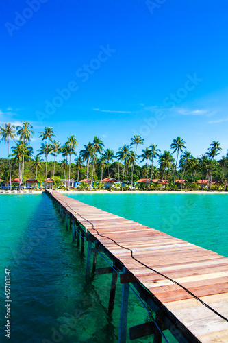 Fototapeta Naklejka Na Ścianę i Meble -  Tropical Resort.  boardwalk on beach