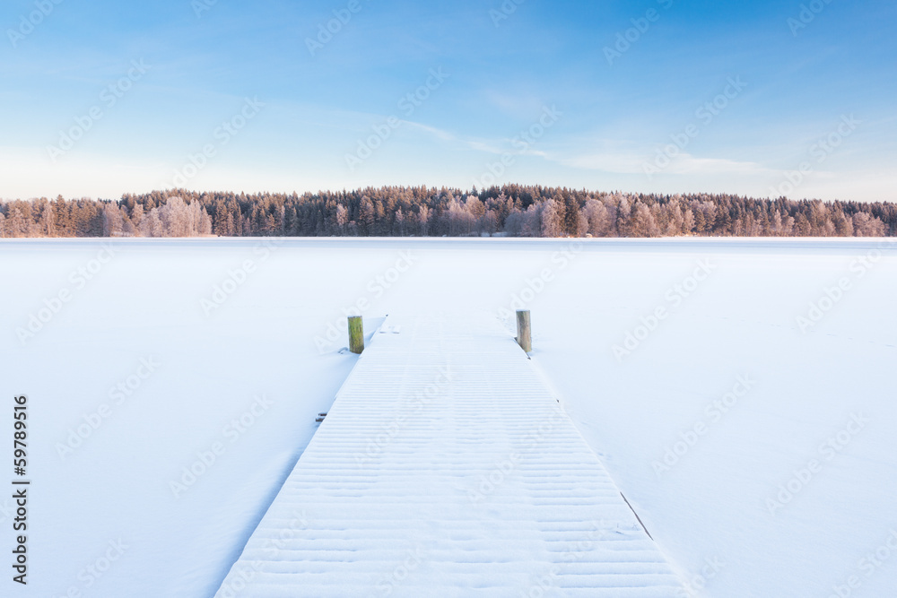 Fototapeta premium frozen snowy lake and a pier
