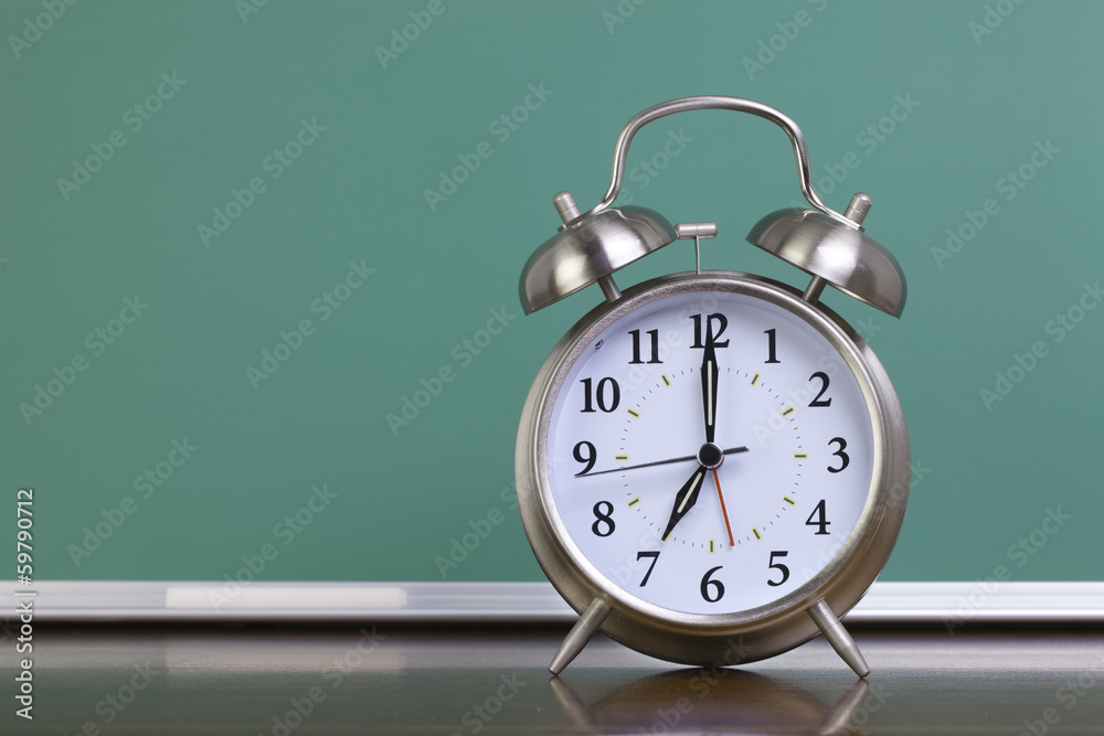 Alarm clock and green chalkboard Alarm clock and green chalkboard