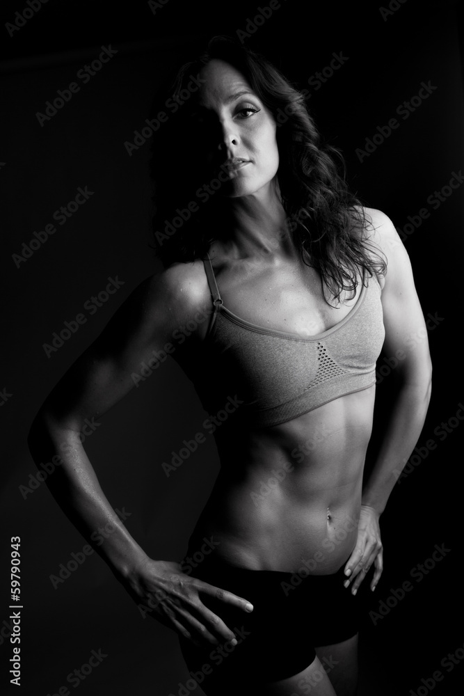 A beautiful woman with a tanktop ready for exercise A beautiful woman with a tanktop ready for exercise