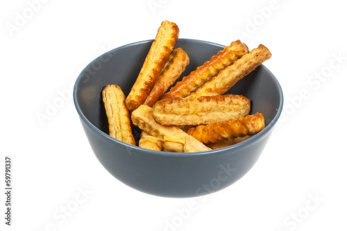 Puff pastry sticks  on a plate on isolated background