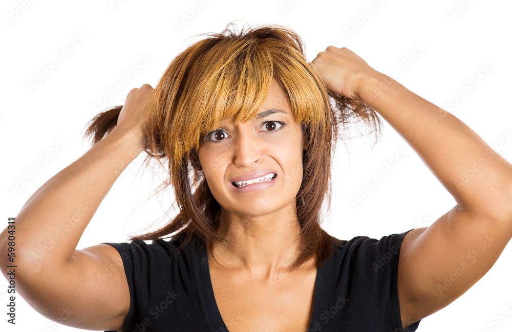 Woman stressed is going crazy pulling her hair in frustration