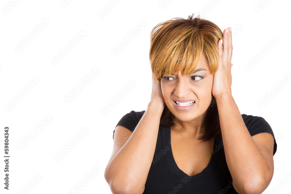 Stressed woman covering her ears with hands 