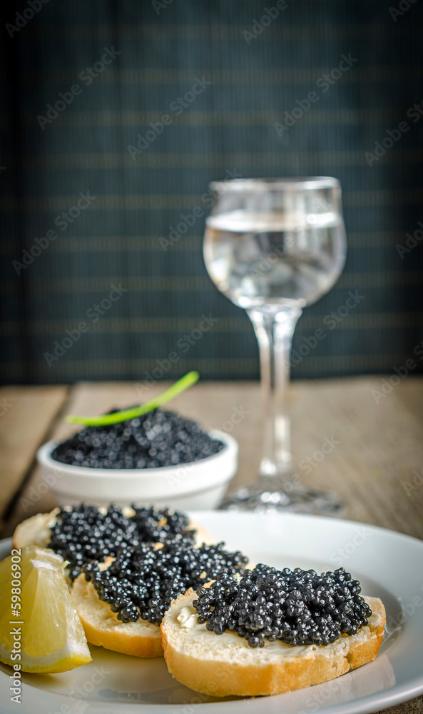 Sandwiches with black caviar and glass of vodka Sandwiches with black caviar and glass of vodka