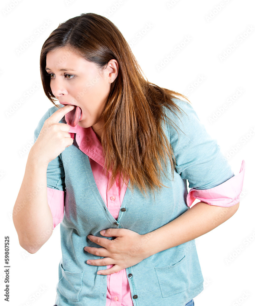 Young woman sticking finger in her throat, about to vomit Stock Photo