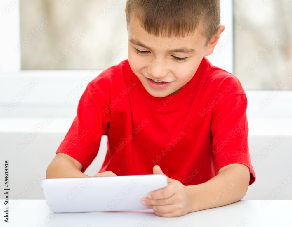 Young boy is using tablet