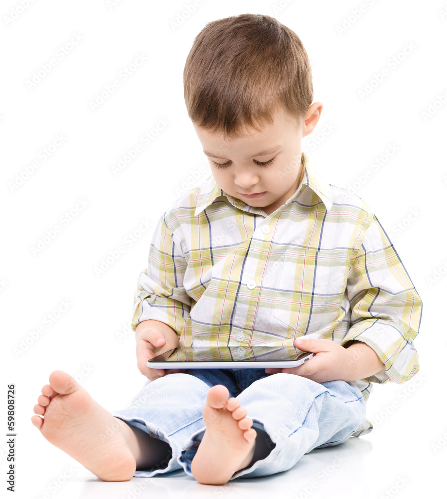 Young boy is using tablet