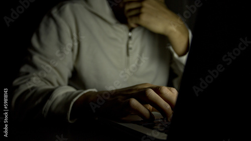 Concept of internet addiction, man on laptop at night