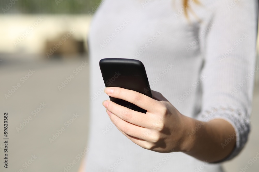 Woman hand holding and browsing a smart phone outdoor Woman hand holding and browsing a smart phone outdoor