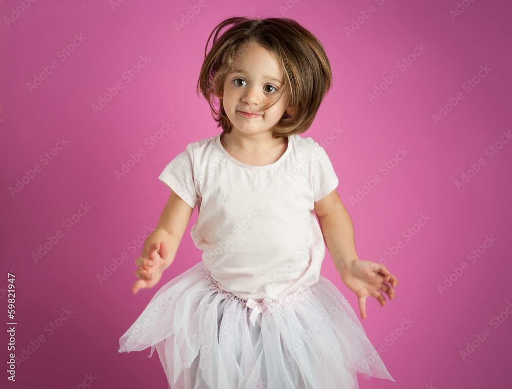 Young dancer girl portrait against pink background. Young dancer girl portrait against pink background.