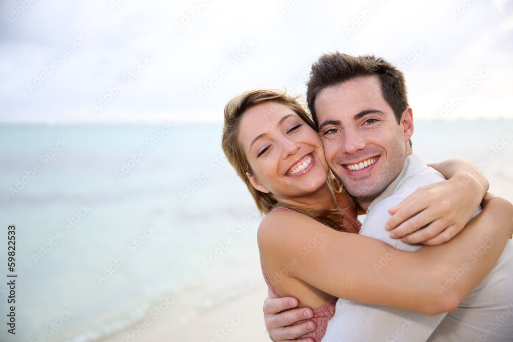 In love couple embracing by the beach