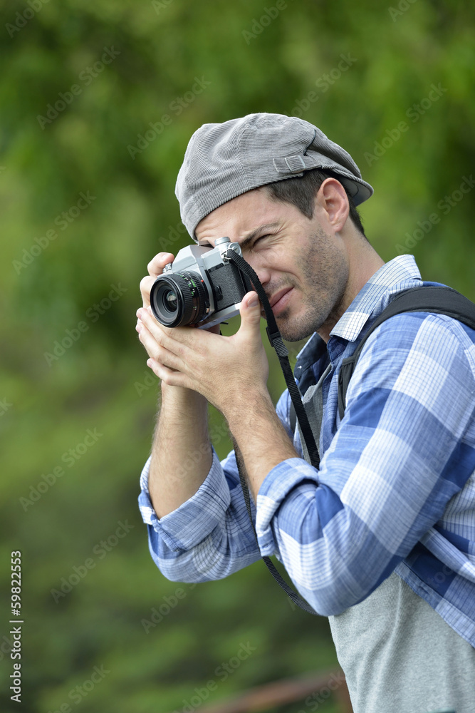 Man taking picture with old-fashioned camera Man taking picture with old-fashioned camera