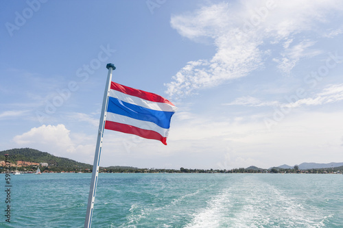 Thailand flag with boat wake at Koh Pha Ngan island