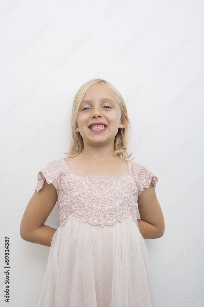 Portrait of girl smiling against white background
