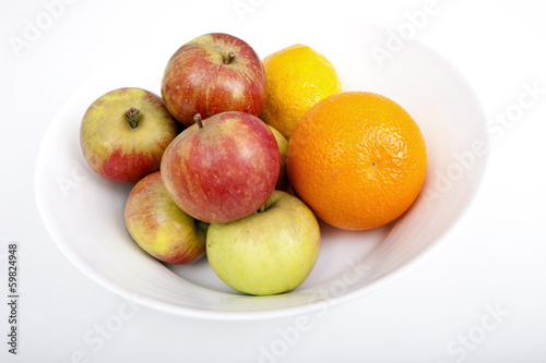 Fresh fruits in plate against white background