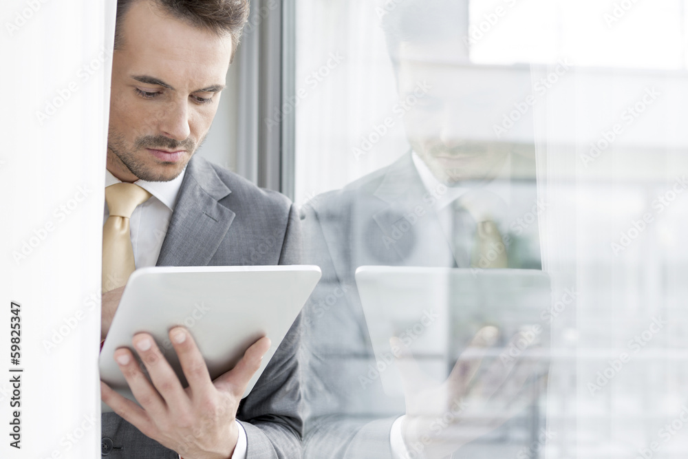 Businessman using digital tablet in office