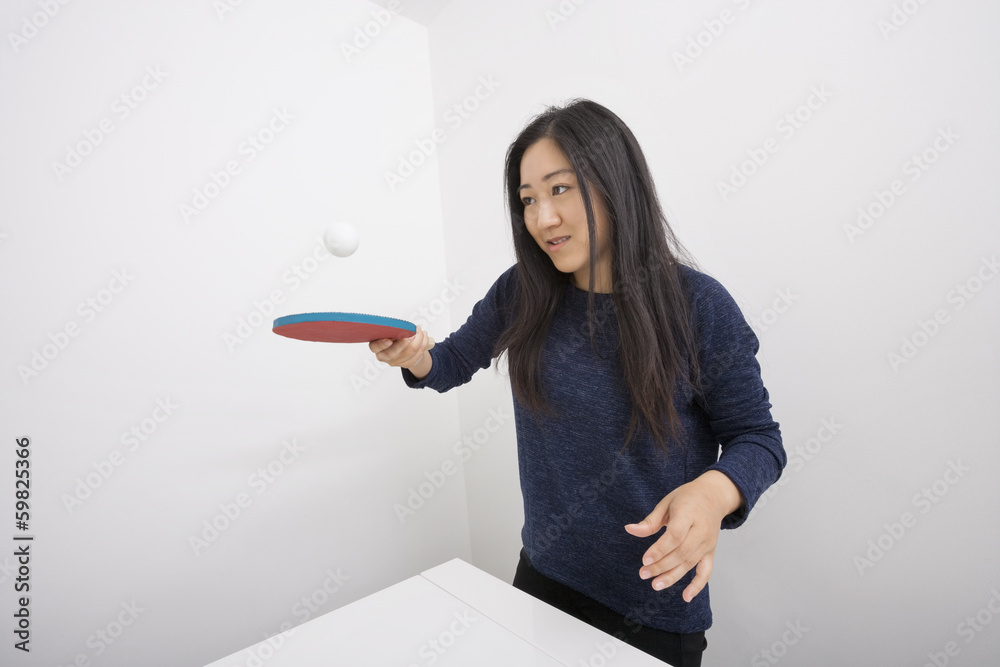 Female table tennis player bouncing ball on paddle Female table tennis player bouncing ball on paddle