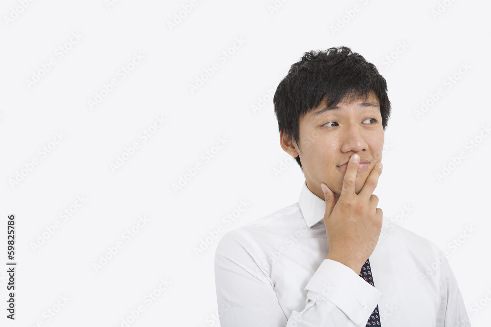 Thoughtful mid adult businessman over white background Thoughtful mid adult businessman over white background