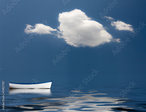 Schilderij op canvas Old rowing boat marooned at sea
