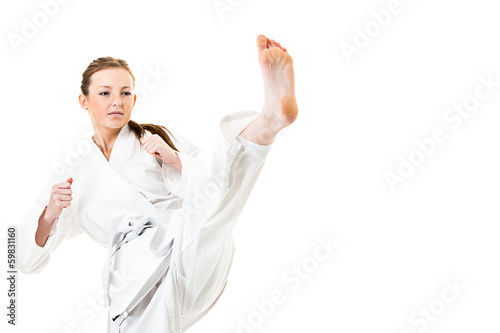 Beautiful caucasian, young, woman makes a kick in kimono on whit