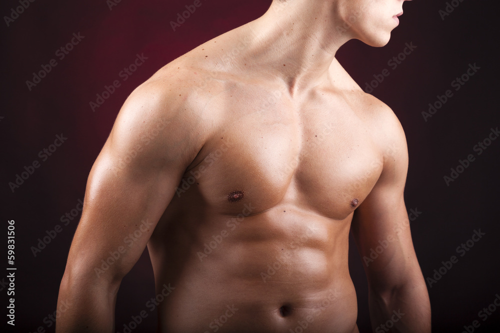 Cropped image of a beautiful man torso against black background Cropped image of a beautiful man torso against black background