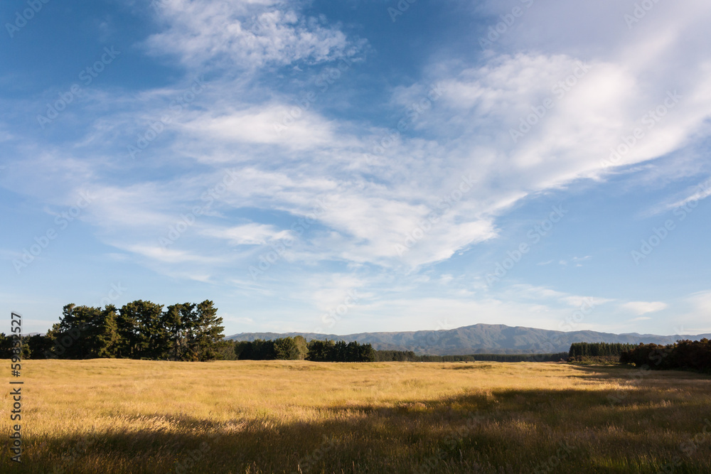 cirrus clouds above rural countryside