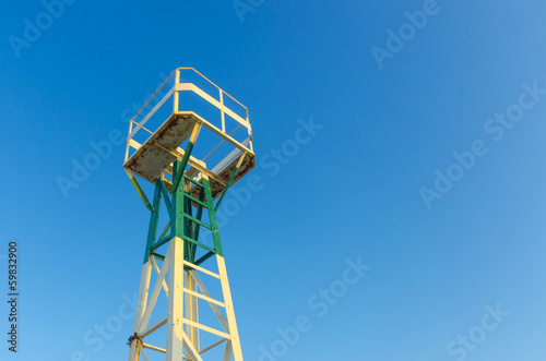 sea port lighthouse tower with lookout and blue sky