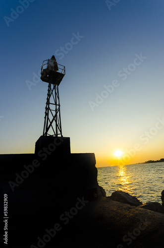 sea port lighthouse tower silhouette with lookout 