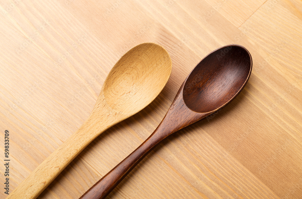 Wooden teaspoon over the wooden background Wooden teaspoon over the wooden background