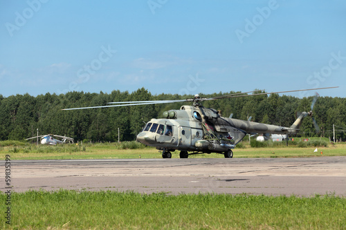 The military helicopter at the airfield