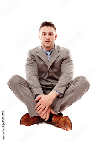 Bilde på lerret Positive businessman sitting cross legged